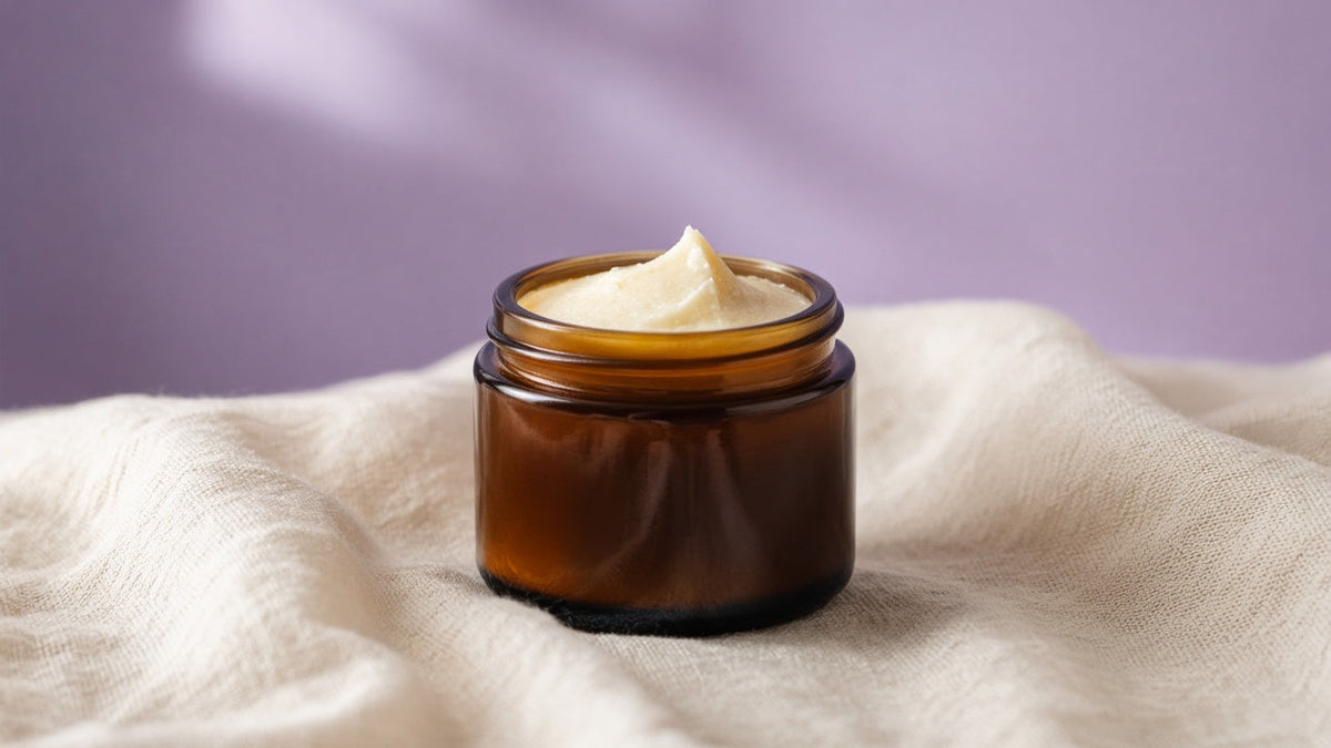 Amber tallow balm jar on linen with soft lavender light