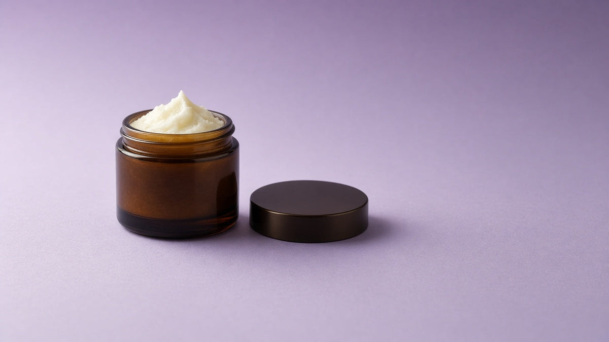 Single amber jar of handmade tallow balm on a soft lavender background